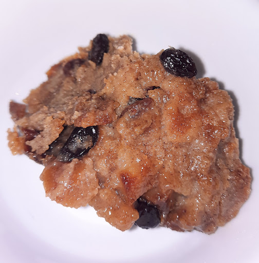 Scoop of cold bread pudding on a plate