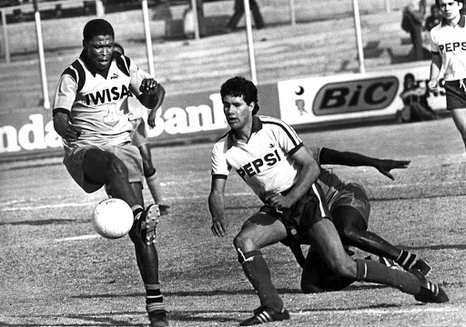 Jackie Masike clears in front of Brian Stoddart of Arcadia Pepsi on July 26 1981.