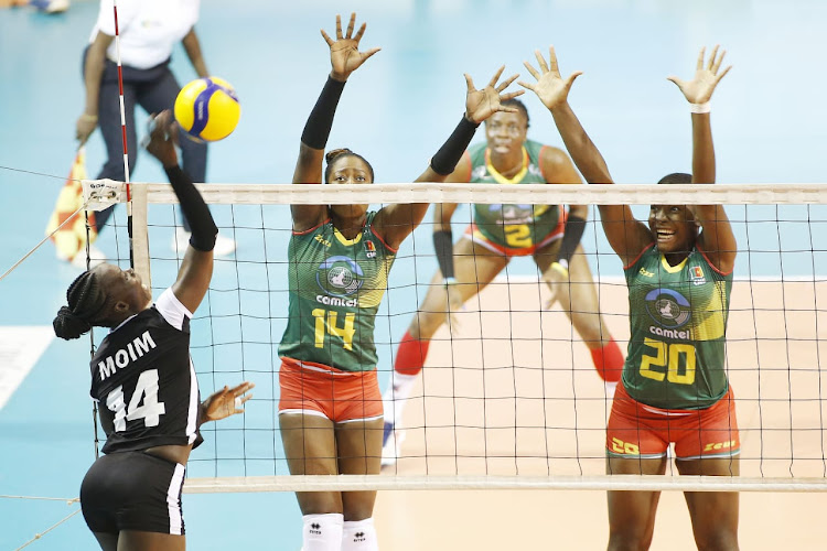 Captain Mercy Moim spikes the ball against Cameroon players on Tuesday night.