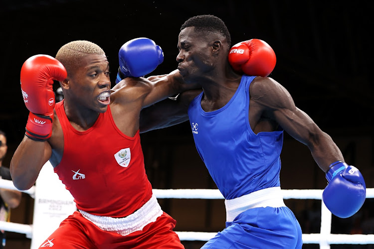 Simnikiwe Bongco (red) in action in his tournament opener against Foday Badjie of The Gambia.