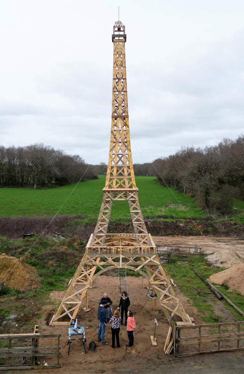 A drone view shows a 16-meter replica of the Eiffel Tower from recycled wood.