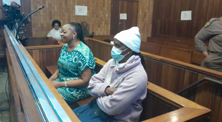 Rosemary Ndlovu (left) and Nomsa Mudau seated next to each other in the Kempton Park regional court. The pair stand accused of conspiring to kill Mudau's husband, Justice, in February 2018.