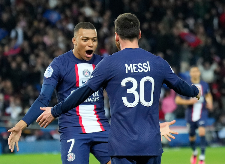 Paris Saint Germain's Kylian Mbappe (L) celebrates after scoring with his teammate Lionel Messi during a French Ligue 1 match on April 15