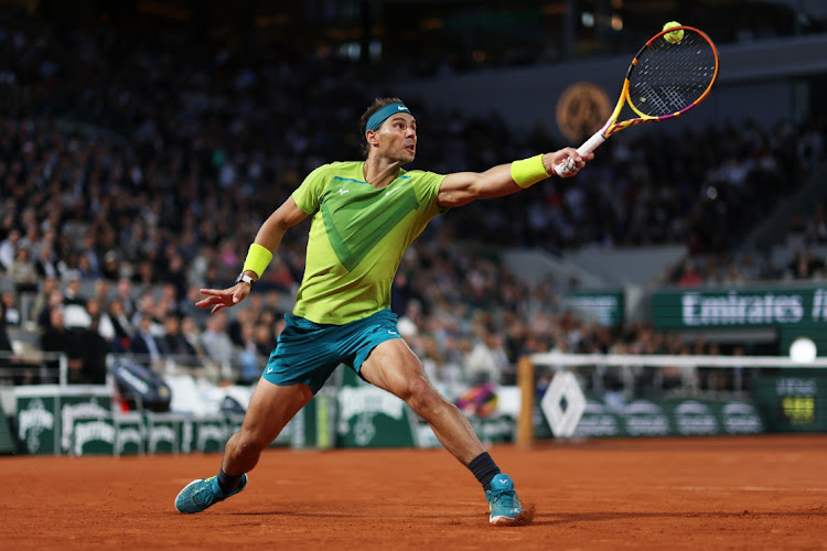 Rafael Nadal stretches to play a backhand against Novak Djokovic during the 2022 French Open at Roland Garros on May 31 2022 in Paris, France. Picture: GETTY IMAGES/CLIVE BRUNSKILL