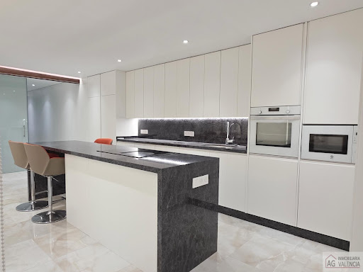 Buy this luxury property in Valencia (Spain) - Modern kitchen with central island, stools