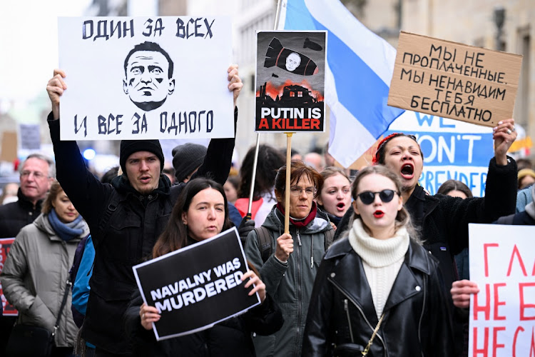 People hold placards at a rally after the death of Russian opposition leader Alexei Navalny, in Berlin, Germany, February 18 2024.