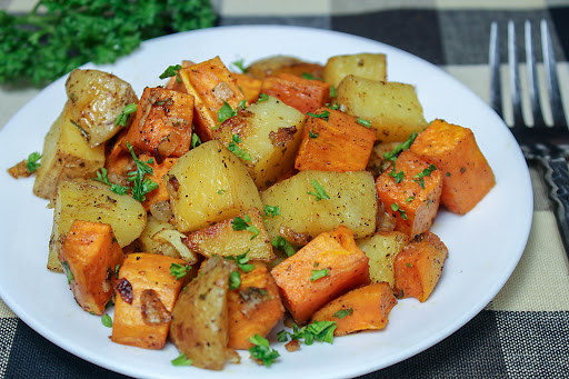 Roasted Yukon Gold and sweet potatoes on a plate.