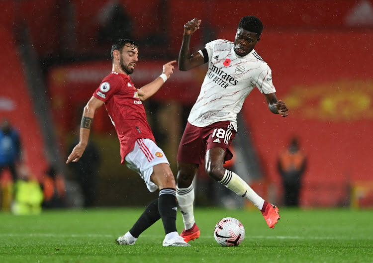 Arsenal's Thomas Partey (right) in action with Manchester United's Bruno Fernandes during the English Premier League game at Old Trafford, Manchester on November 1, 2020