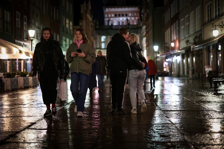 Dariia Vynohradova, 17, from Kharkiv, kisses her boyfriend Dmytro Demchevskyi, 18, from Yuzhnoukrainsk, during an evening walk in the Old Town in Gdansk, Poland, on February 21 2024. Picture: REUTERS/KACPER PEMPEL