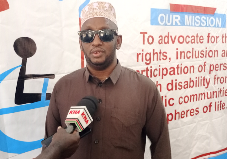 Abdi Ali Gamadid,a PWD champion speaking to the press.