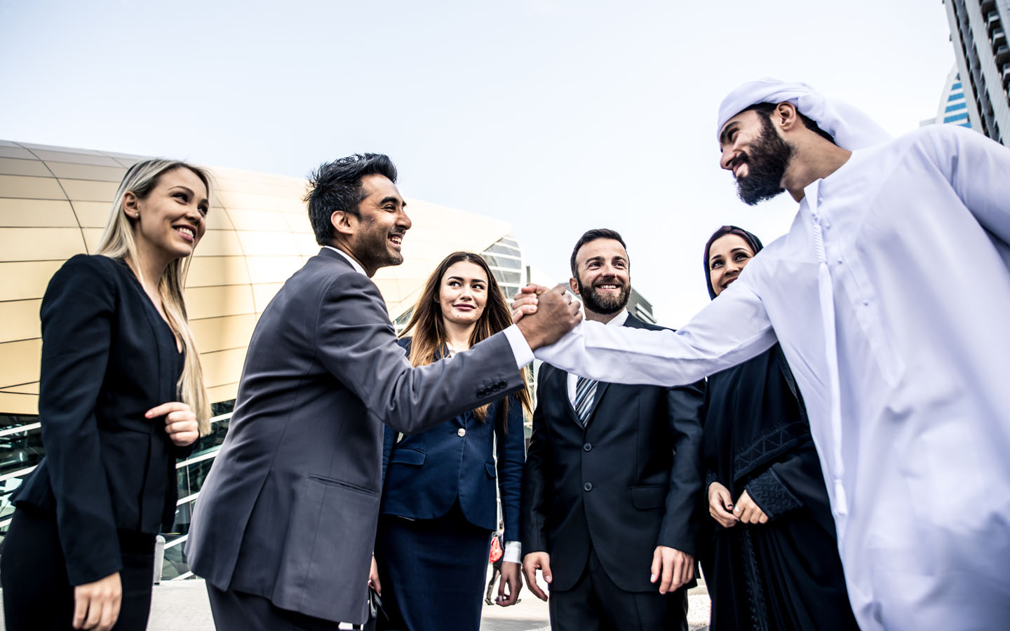 arab man shaking hands with businessman over a done deal