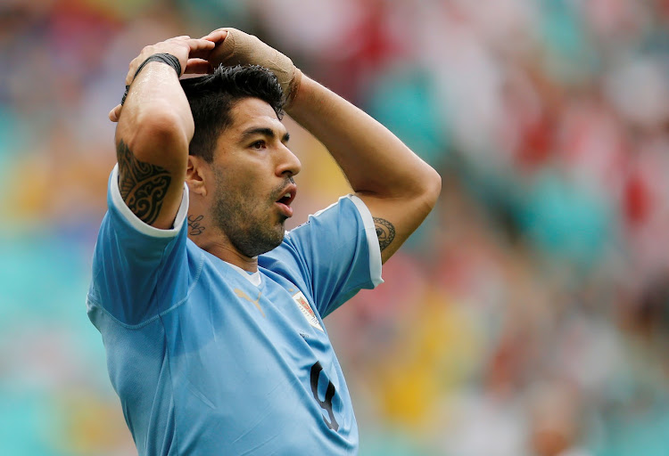 Uruguay's Luis Suarez reacts after missing penalty against Peru