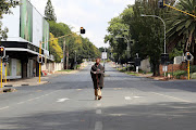 Homeless man Sifundo Mkhize walks on the deserted Oxford Road in Sandton on Friday March 27.