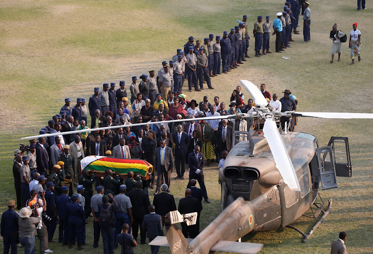 The casket carrying the body of former Zimbabwean President Robert Mugabe is carried to the military chopper after lying in state at the Rufaro stadium, in Mbare, Harare, Zimbabwe.