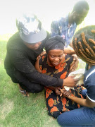 Anto Mpianzi being comforted by family members as she reached the place  where her  son's body was found.