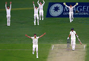 Australia's Pat Cummins appeals with team mates for LBW to dismiss England's Joe Root during the first day of the first Ashes cricket test match. 