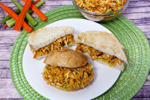 Asian chicken salad on bread on a white plate.