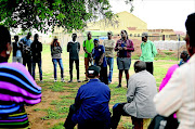 Residents gather under a tree outside  the Disaneng tribal offices to voice their displeasure about their chief and his handling of   community affairs. Photo: Tiro Ramatlhatse