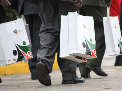 Members of the public with copies of Kenya's 2009 census results announced at the KICC in Nairobi in August 2010.