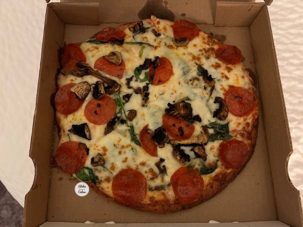 Gluten free pizza with pepperoni, basil and mushrooms