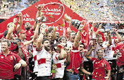 Golden Lions players celebrate after winning the 2015 Currie Cup final at Ellis Park.