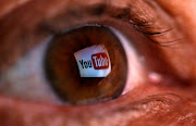 A picture illustration shows a YouTube logo reflected in a person's eye June 18, 2014.  