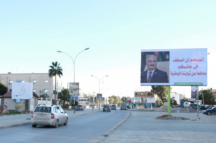 A billboard with an image of Libya's eastern commander and presidential candidate Khalifa Haftar is pictured by a roadside in Benghazi, Libya December 22, 2021