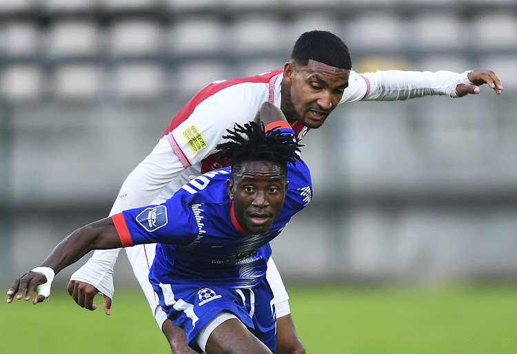 Karim Kimvuidi of Maritzburg United competes for the ball with Morne Nel of Cape Town Spurs in their promotion playoff match at Athlone Stadium in June. Kimvudi has signed for Orlando Pirates.