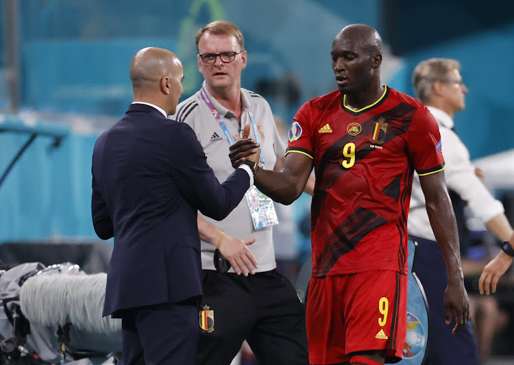 Belgium's Romelu Lukaku shakes hands with coach Roberto Martinez