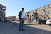 Dominique Caswell stands outside the blocks of flats in Lavender Hill where he often is called to meet with clients. 