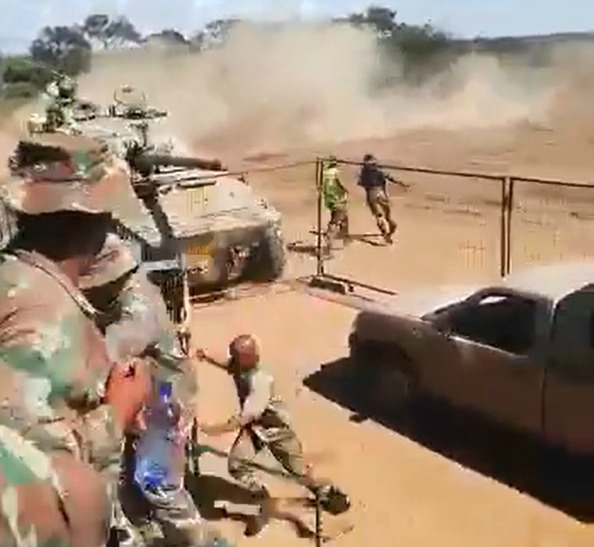 A screenshot from the video shows SANDF members ducking for cover as the driver of a tank misjudges a corner and almost crashes into members during a routine demonstration on Monday.