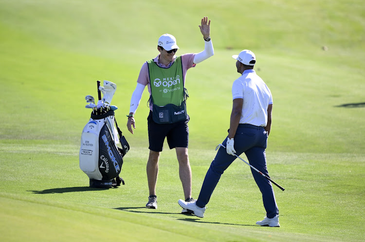 Erik van Rooyen and his caddie share a moment after he holed out on the 12th hole during the first round of the Mexico Open at Vidanta Vallarta.