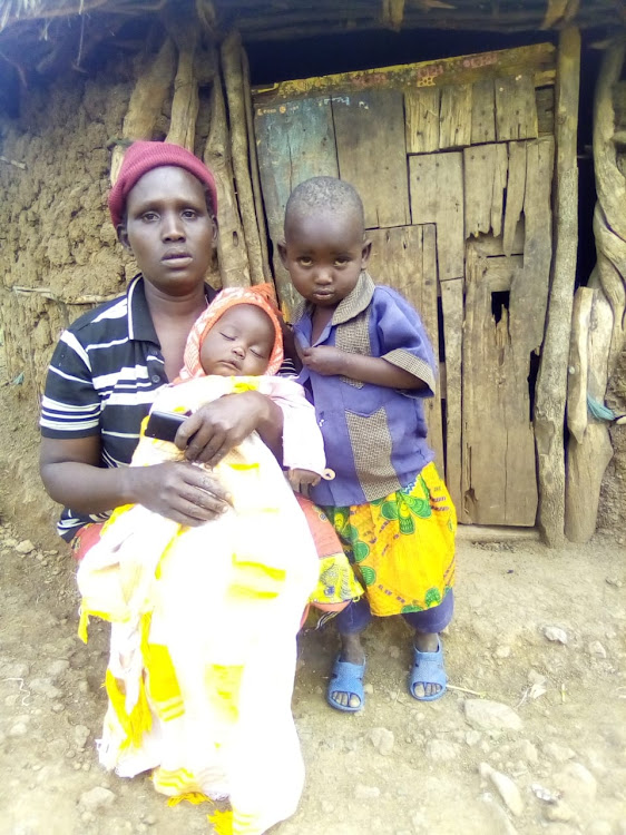 Stella Chebon, widowed second wife of lynched goat thief, mourns with children outside their grass-thatched hut at Kibenos in Sibilo, Baringo North subcounty, on Monday.