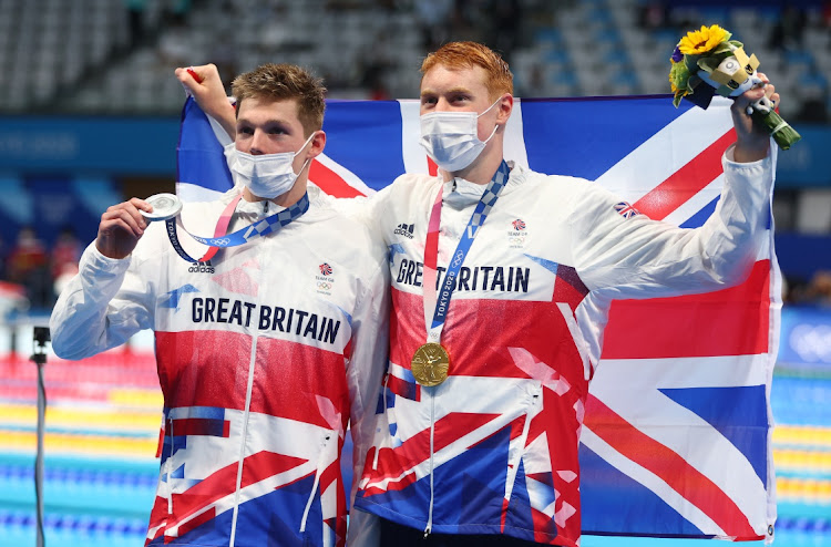 Tom Dean of Britain and Duncan Scott of Britain pose with their gold and silver medals after the Tokyo 2020 Olympics men's 200m freestyle on July 27, 2021