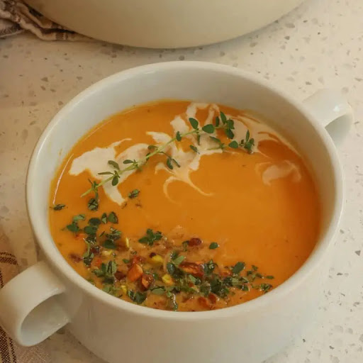 Smooth and creamy Sweet Potato Soup is quick and easy to make. With hints of ginger, cumin, and paprika and topped with toasted coconut flakes and chopped pistachios it is full of flavor and texture.