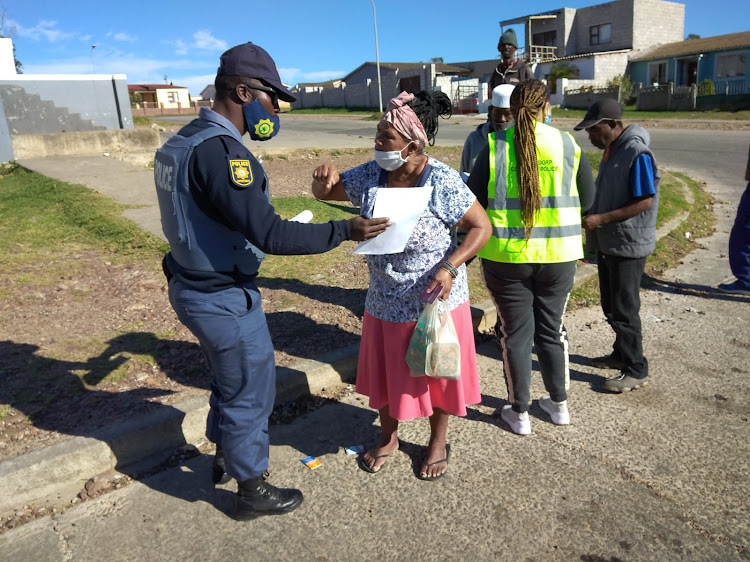 Police hand out pamphlets during an initiative to raise awareness among the elderly in Gqeberha this week