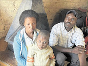 RELIEVED BUT ANGRY: Thapelo, his face and head covered in dust, is with his mother Johanna Sithole and  grandfather, Elias Sithole.