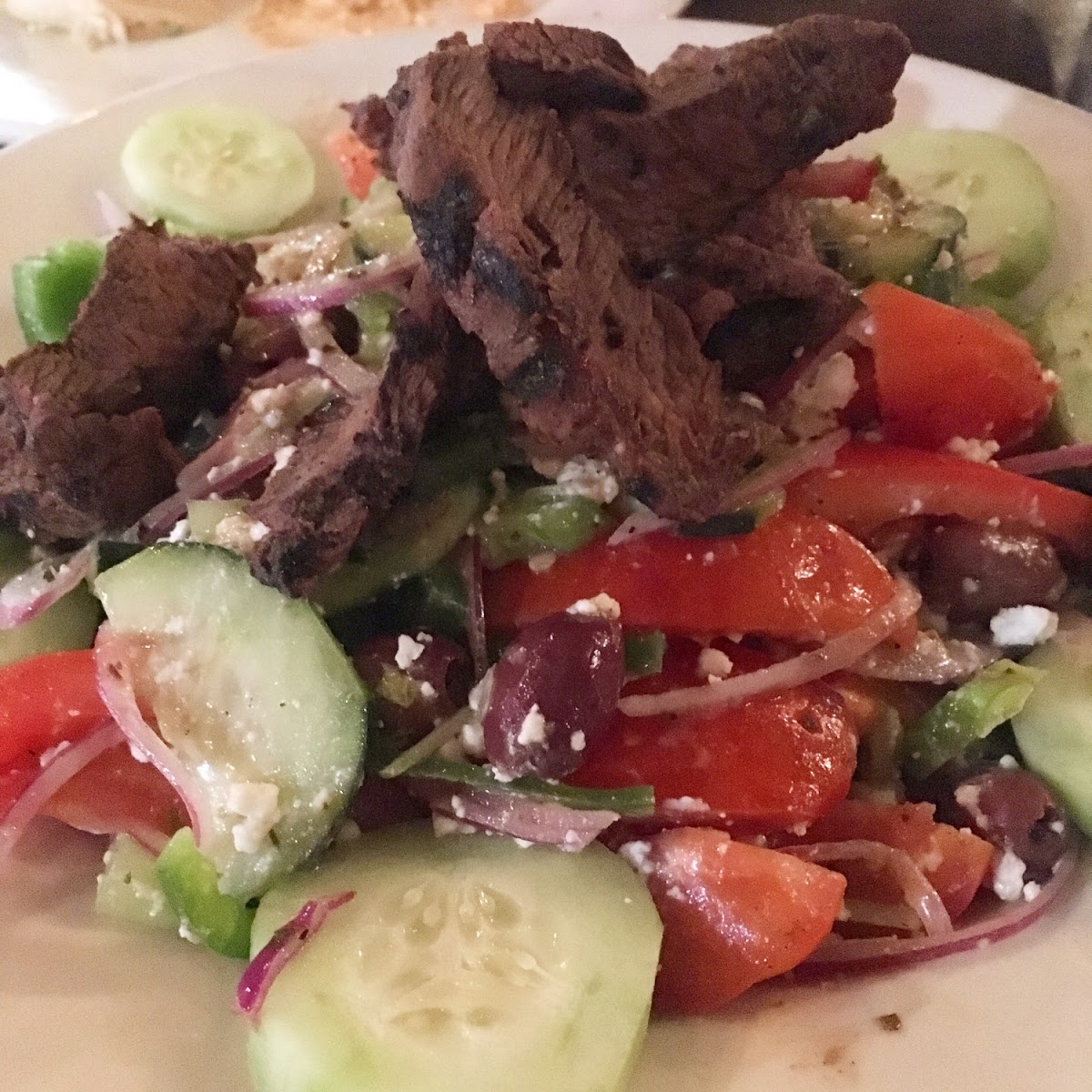 Horiatiki salad with the tastiest steak on top