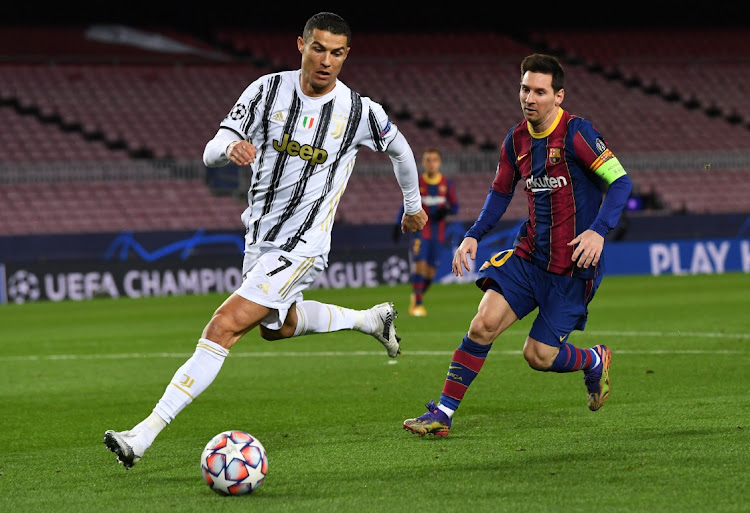 Cristiano Ronaldo of Juventus is put under pressure by Lionel Messi of Barcelona during the UEFA Champions League Group G match at Camp Nou on December 8, 2020 in Barcelona