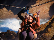 Marie Fick, 94, waves for the camera as she rockets across the bay on the world's longest over-sea zipline.