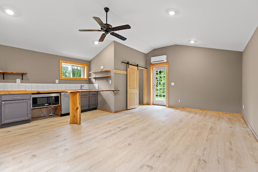 Living room with kitchen and exterior door - Buy this luxury house in Lookout Mountain, 3 bedrooms