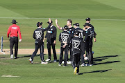 James Neesham of New Zealand (C) is congratulated by team mates after dismissing Tamim Iqbal Khan of Bangladesh during game two of the One Day International series between New Zealand and Bangladesh at Hagley Oval on March 23, 2021 in Christchurch, New Zealand. 