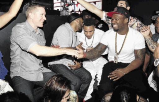 IN DEMAND : 50 Cents clearly enjoys the attention of admirers, as seen here during his birthday party on July 2 at the Orbit in New York City. But the attention he does not want is of people suing him for his cash, as shown by his action of applying for bankruptcy after a court ordered him to pay out R62-million for violation of privacy Photo: Jerritt Clark/Getty Images