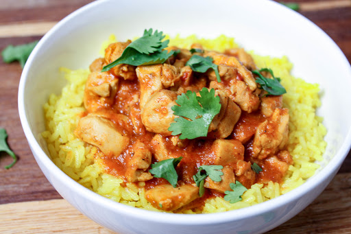 Crock Pot Butter Chicken in a bowl over rice.