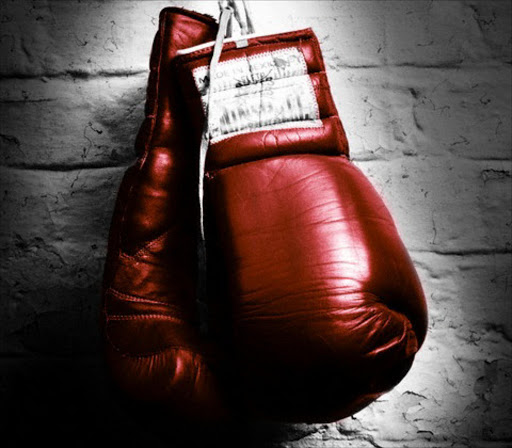 Hanging Boxing Gloves --- Image by © Corbis