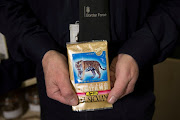 An officer holds a package containing crushed tiger bones. 