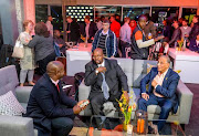 Newly appointed Cricket South Africa (CSA) acting CEO Thabang Moroe (L) shares a discussion with president Chris Nenzani (C) and the now former chief executive Haroon Lorgat (R) during the #T20 Big Reveal at Wanderers Cricket Stadium, Long Room on May 31, 2017 in Johannesburg, South Africa.