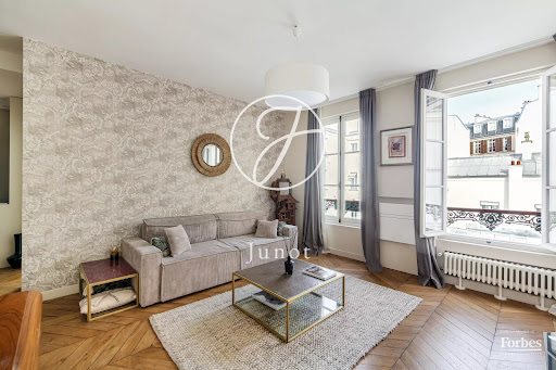 bright living room with parquet floor and Parisian view in this luxury property for sale in Paris 9ème ($1,707,366 - 97 m²)