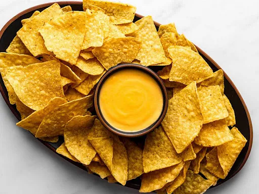 Yellow Nachos Chips With Cheddar Cheese Sauce