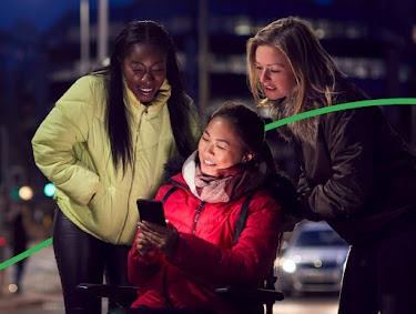 Three people looking at directions on a phone